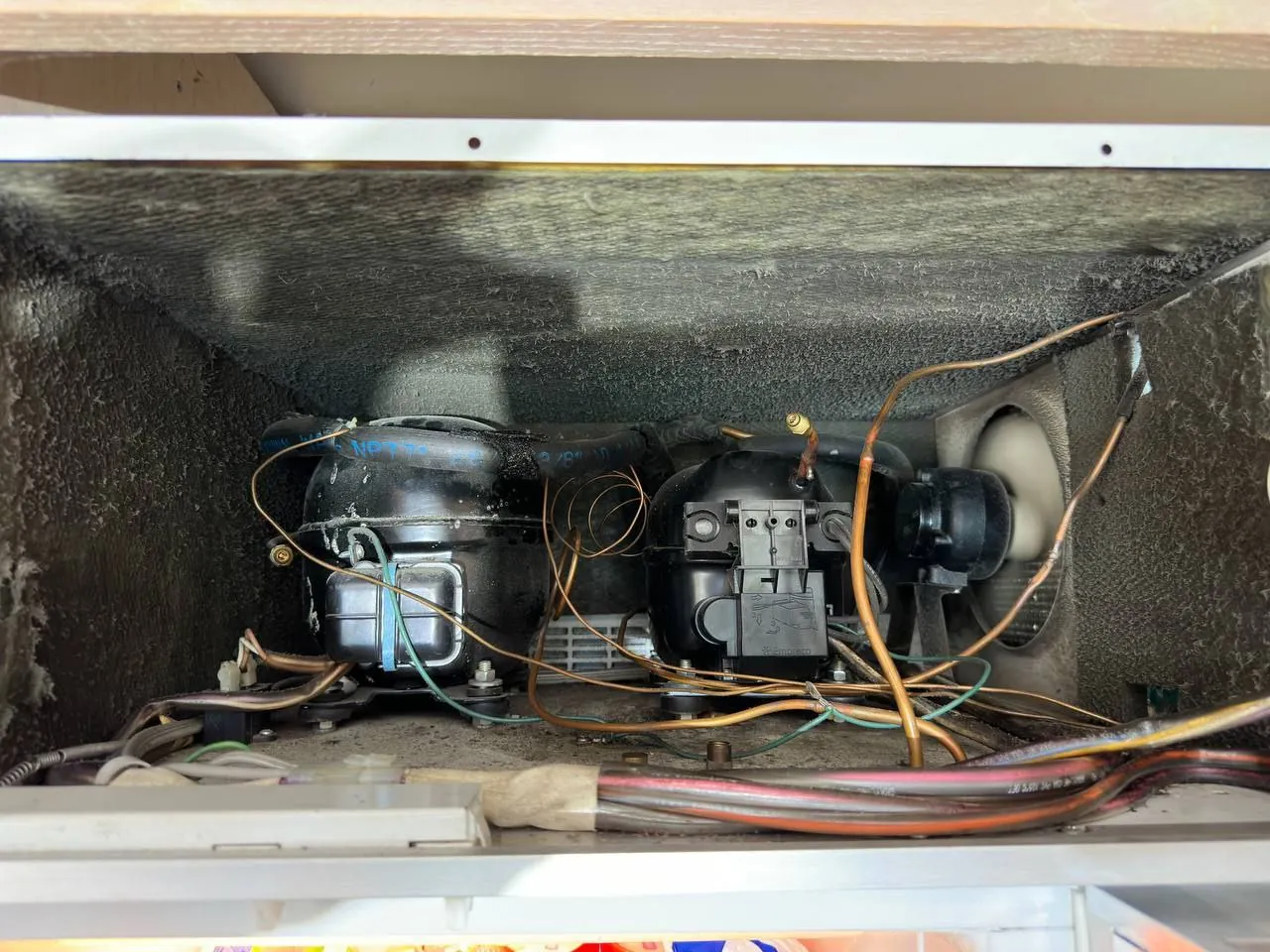 Compressor compartment of a Sub-Zero refrigerator during a sealed-system repair